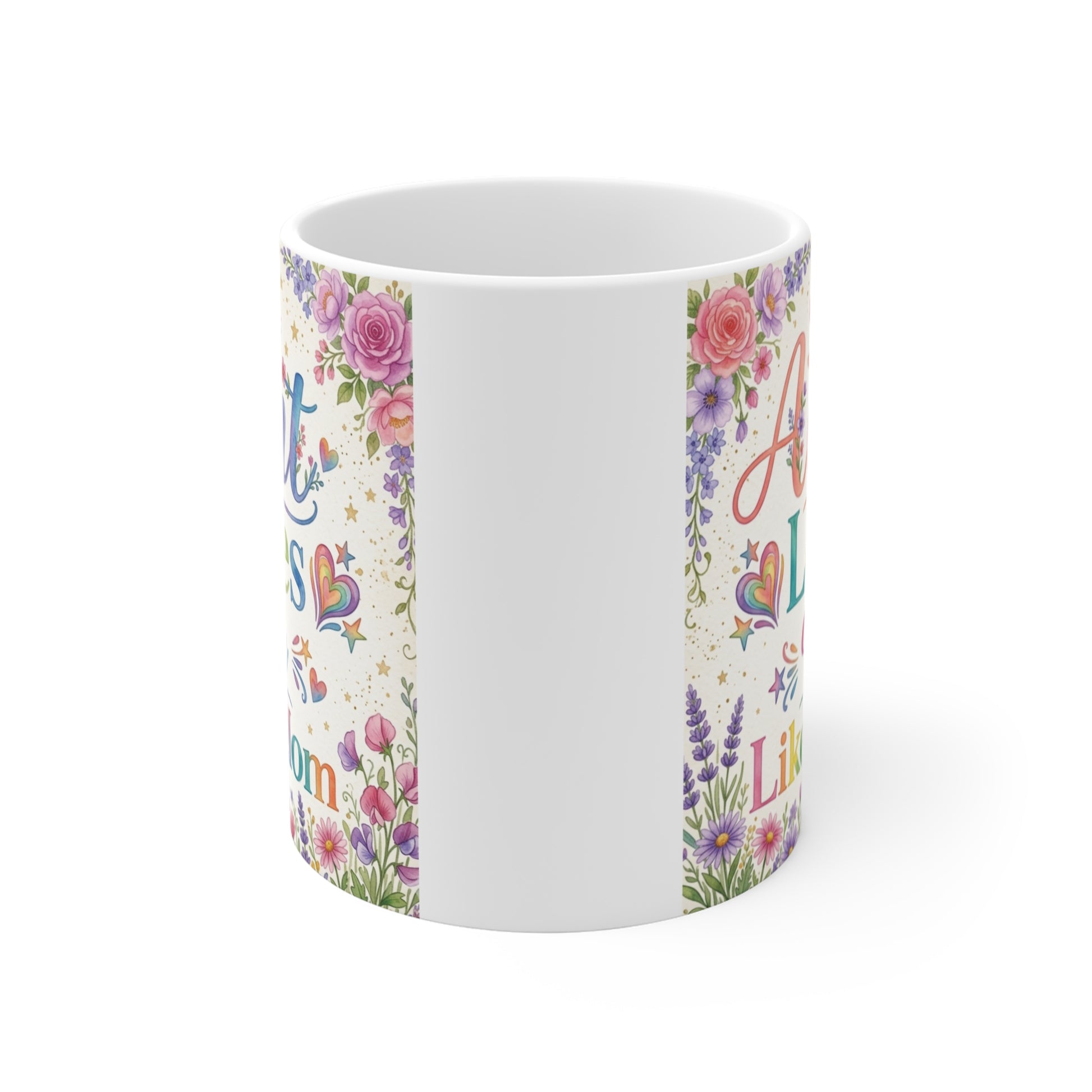 Cute aunt gift mug with vibrant rainbow text "My Aunt Loves Me Like a Mom" surrounded by floral design and decorative hearts on white background