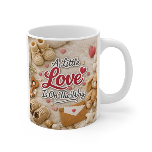 A Little Love Is On The Way 11oz ceramic mug featuring baby booties, plush bunny, hearts, and a cozy neutral baby announcement design.