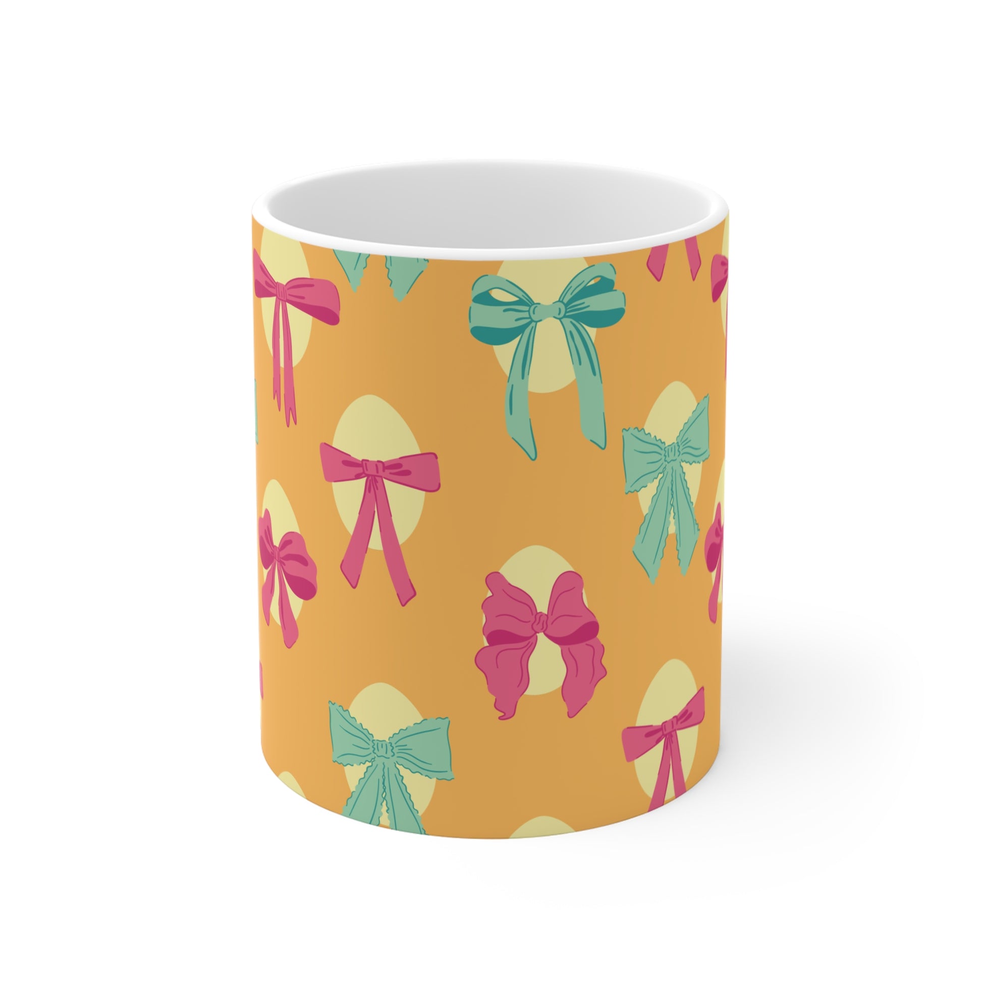 Cute bow pattern coffee mug with pink and teal ribbons on warm yellow background, aesthetic gift for women and girls