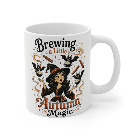 11oz white ceramic mug featuring a cute autumn witch surrounded by floating cinnamon sticks, whipped cream swirls, tiny bats, and the phrase "Brewing a Little Autumn Magic."