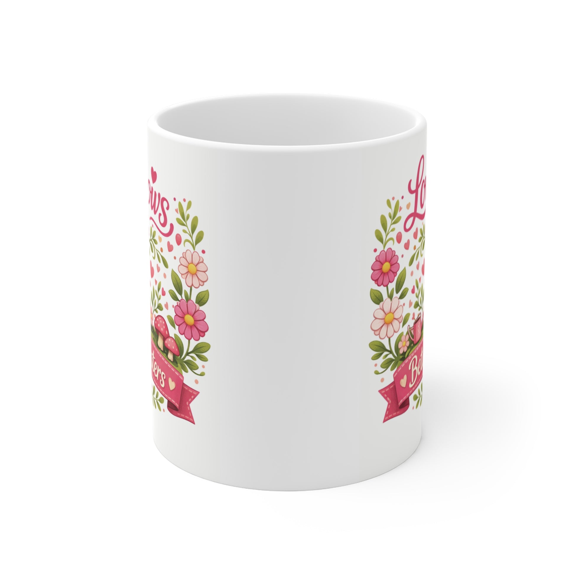 Cute sister gift mug with floral border, pink birds, and hearts surrounding a banner that reads Love Grows Between Sisters.