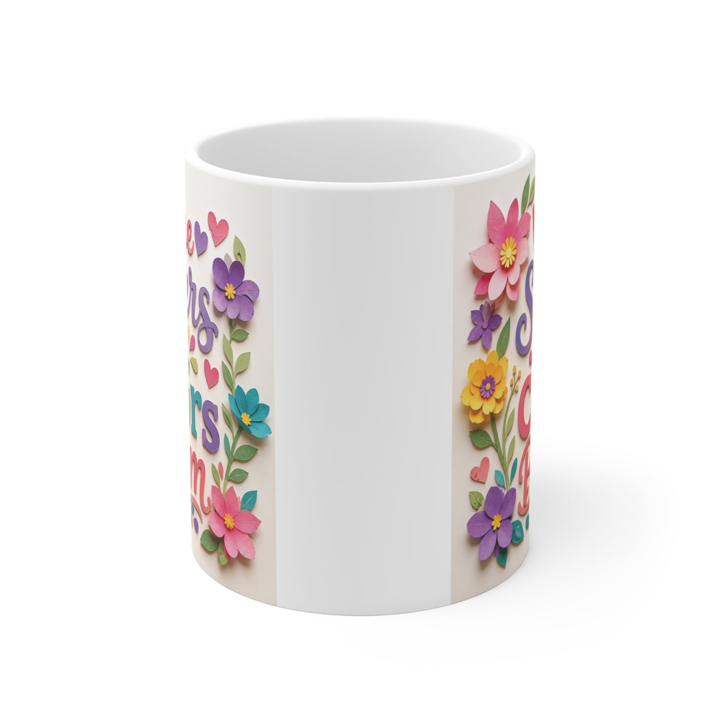 Floral sister coffee mug with the phrase "Where Sisters Are Colors Bloom" in colorful hand-lettered typography, surrounded by layered flowers and heart accents on a white ceramic mug.