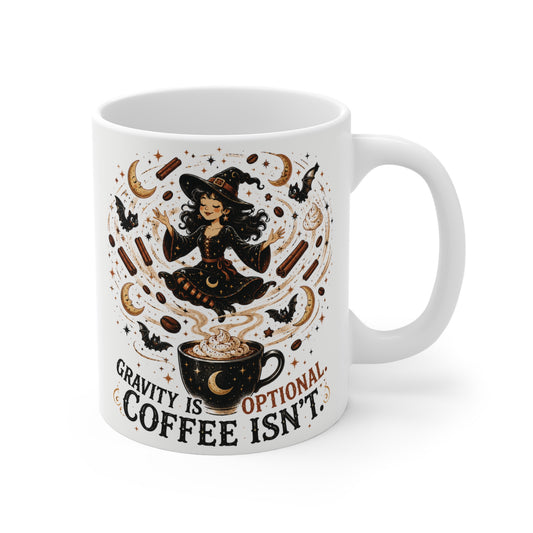 White 11oz ceramic mug featuring a cute cottagecore witch levitating over a coffee cup with the text Gravity is Optional Coffee Isnt