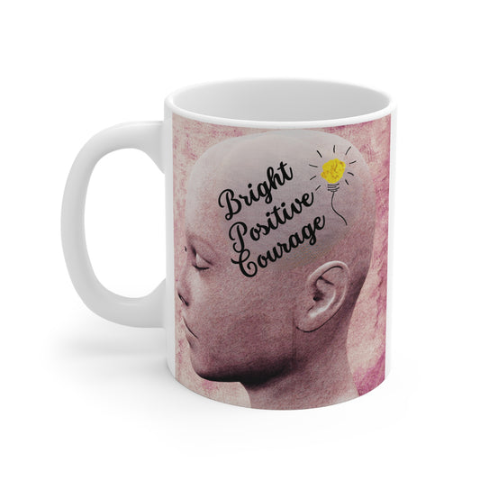 White ceramic mug featuring artistic illustration of a human head with closed eyes, light bulb graphic, and text 'Bright Positive Courage'."