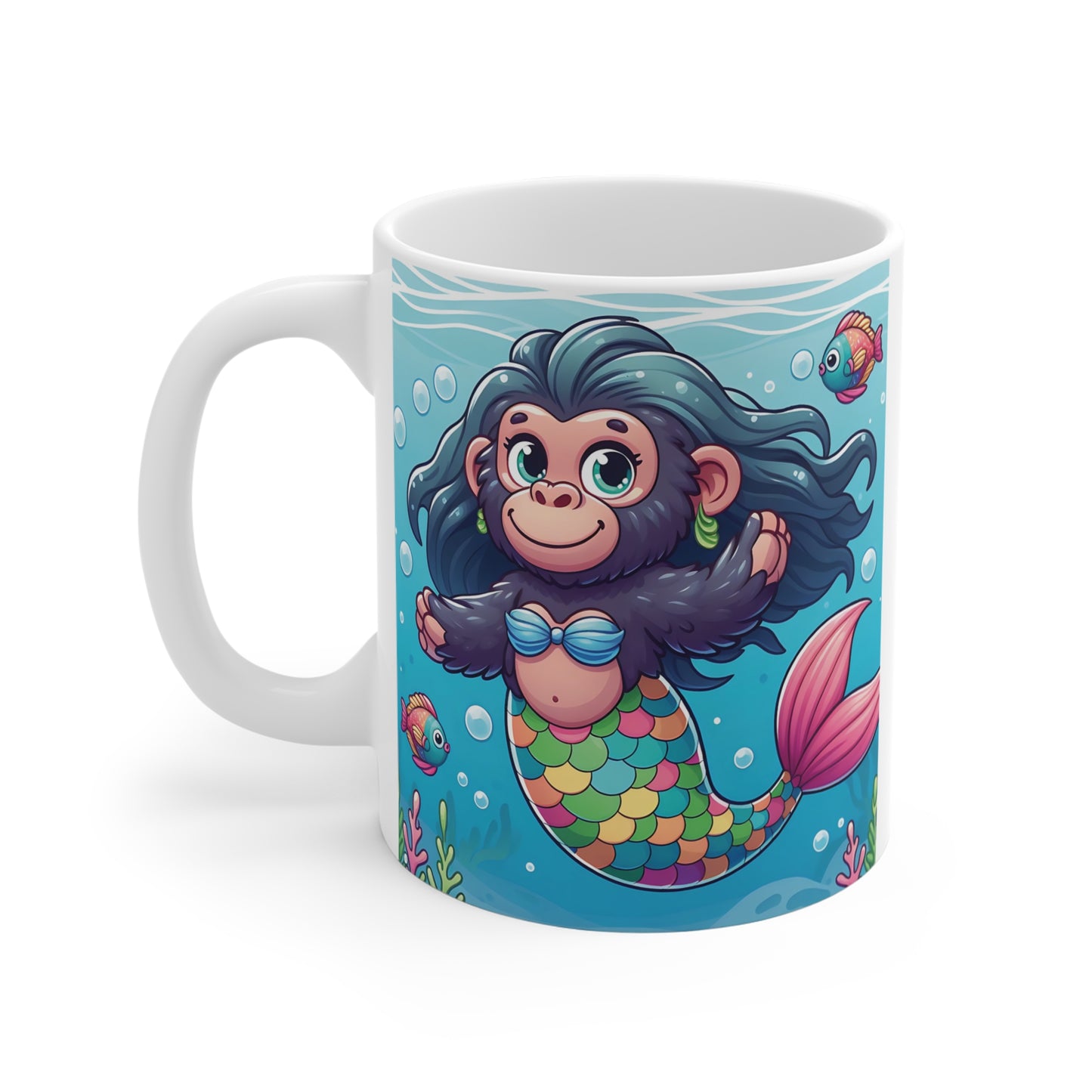 Cartoon monkey mermaid swimming underwater with colorful fish, bubbles, and coral reef artwork on a novelty ceramic mug.