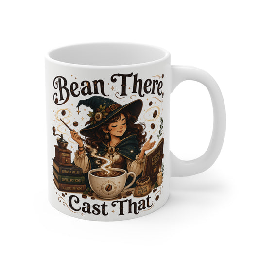 White ceramic coffee mug featuring a cute witch artwork with the text Bean There Cast That