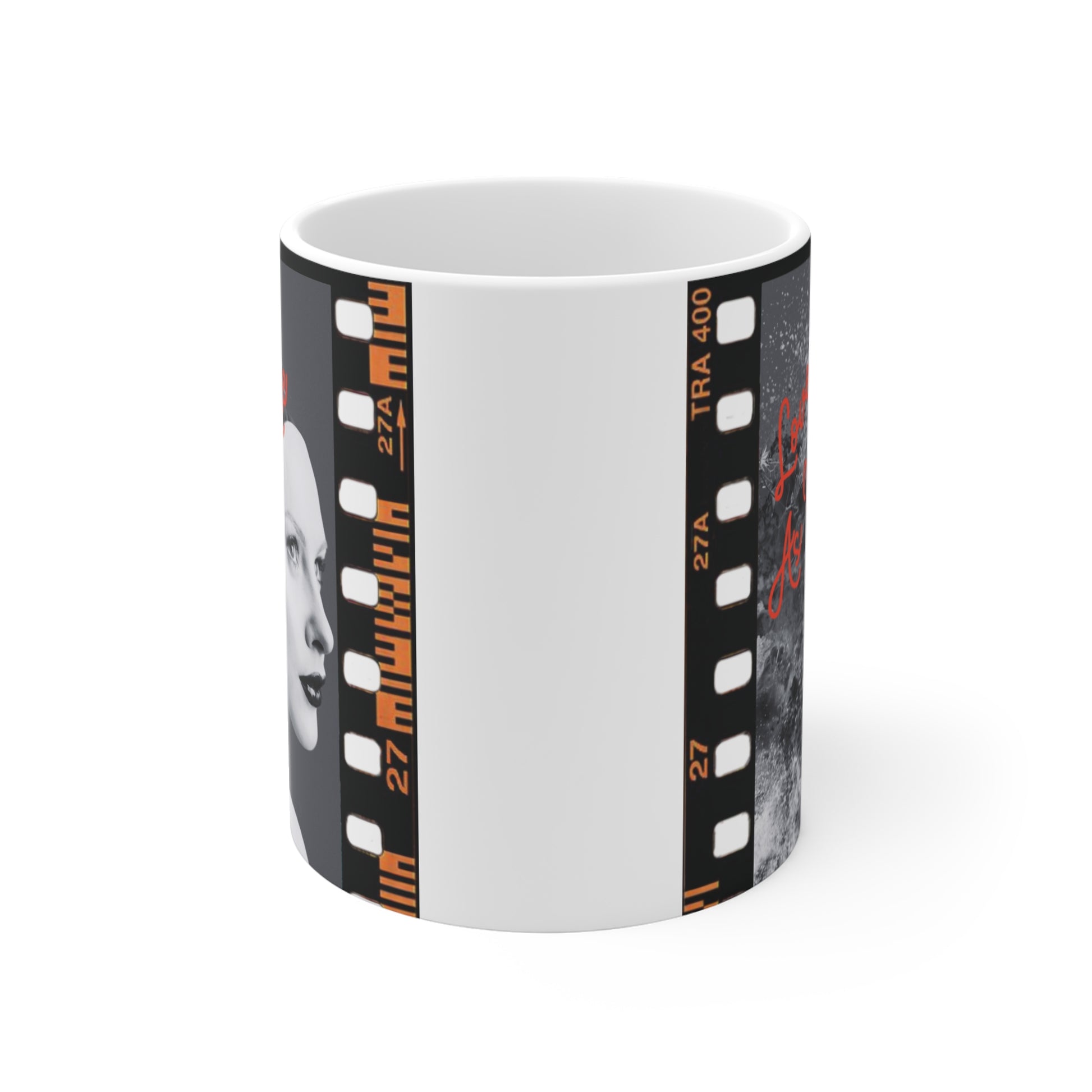 White ceramic mug featuring black-and-white artistic portrait of a woman's face with abstract texture and red text 'Love Us As We Are', filmstrip border design.