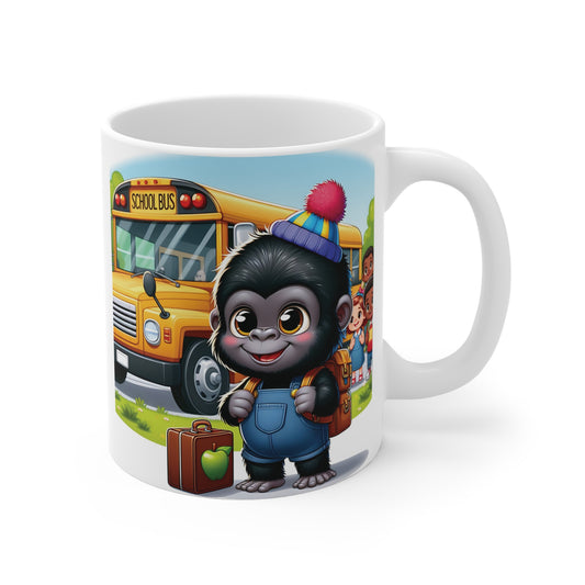 White ceramic mug featuring an adorable baby gorilla wearing a backpack and colorful beanie standing beside a yellow school bus, ready for the first day of school.