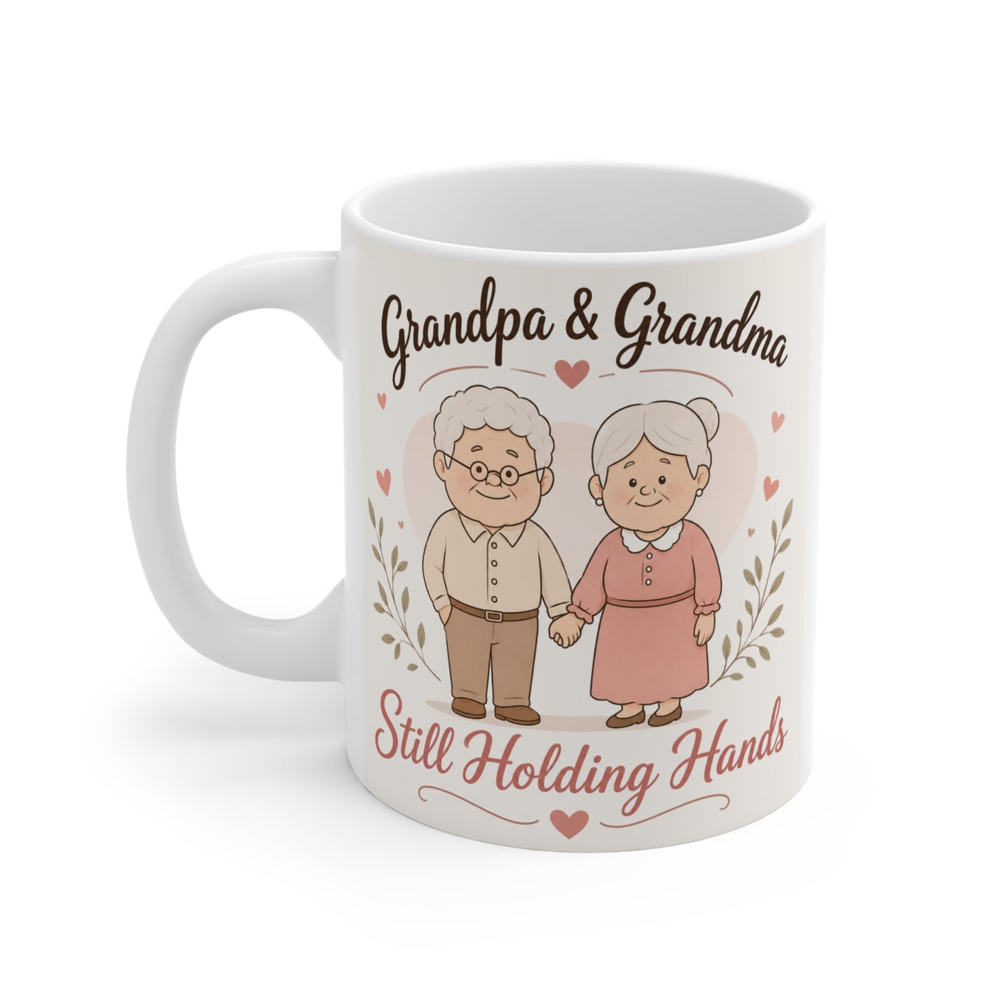 White ceramic 11oz mug decorated with a charming cartoon grandpa and grandma holding hands, surrounded by hearts and leaves, featuring the heartfelt message "Still Holding Hands."