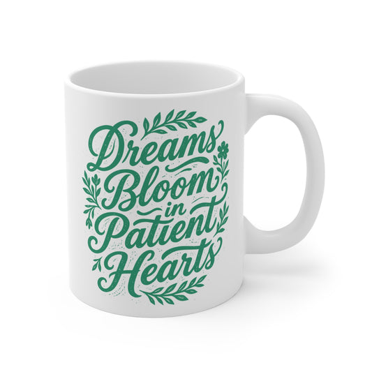 Inspirational 11oz ceramic coffee mug with green floral typography quote Dreams Bloom in Patient Hearts