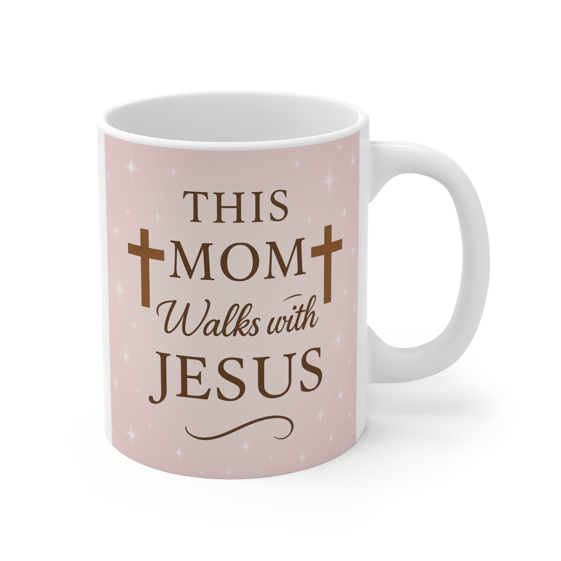 Pink Christian coffee mug with “This Mom Walks with Jesus” text and cross design