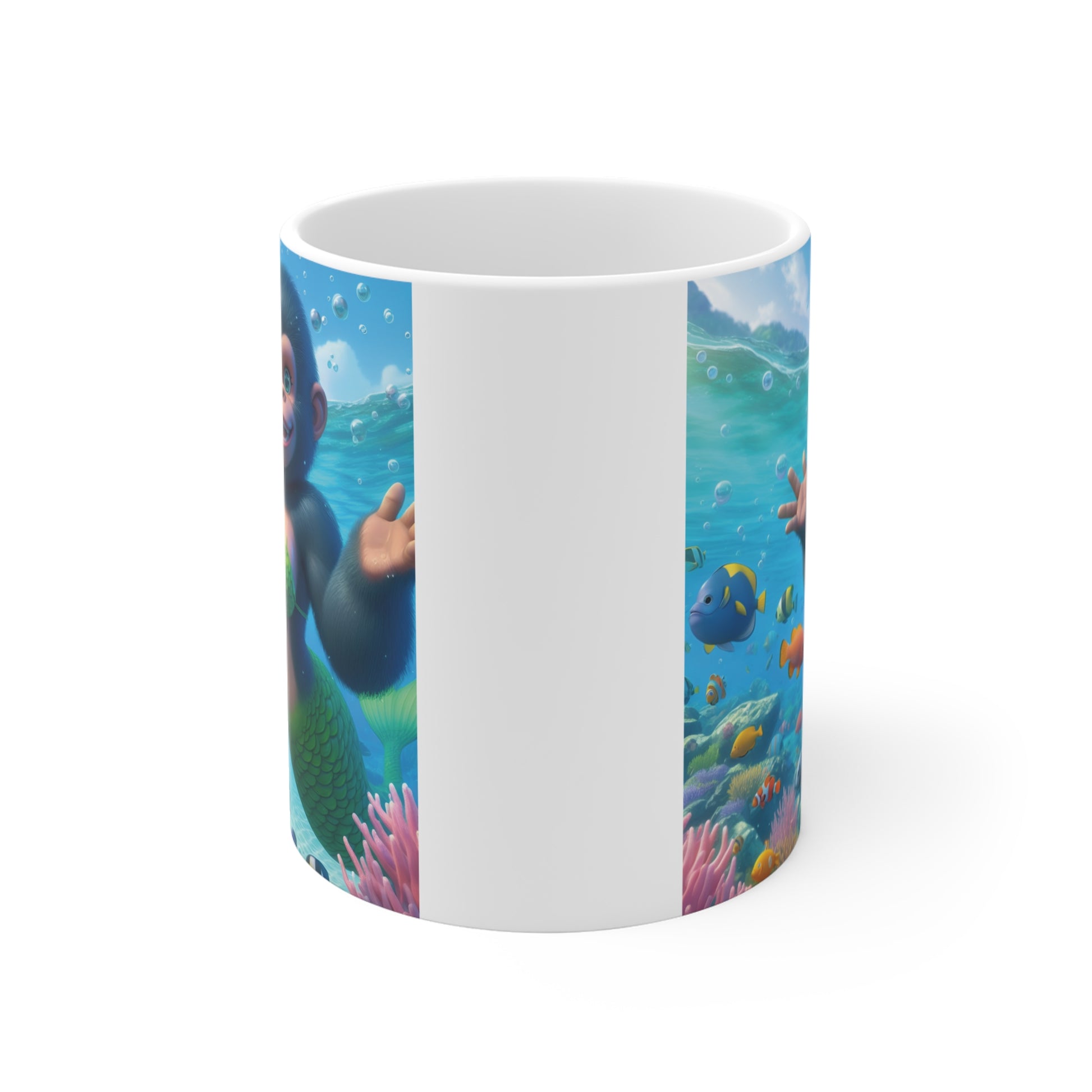 Ceramic coffee mug displaying a cheerful monkey mermaid with a green scaled tail in a vibrant underwater ocean scene filled with fish.