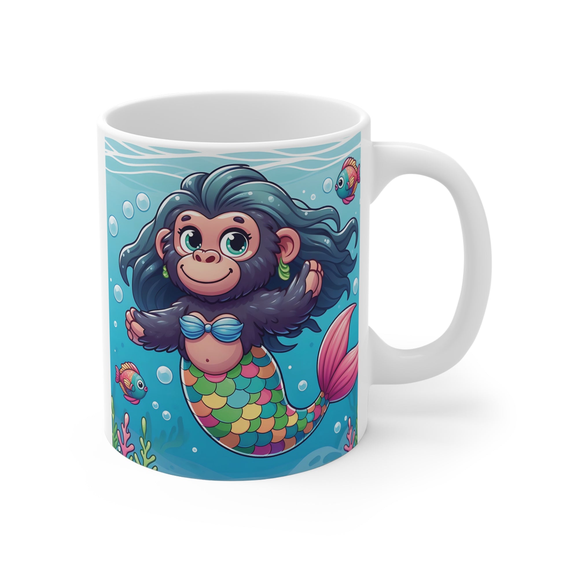 Cute cartoon monkey mermaid with colorful scales swimming underwater among tropical fish, printed on a white ceramic coffee mug.
