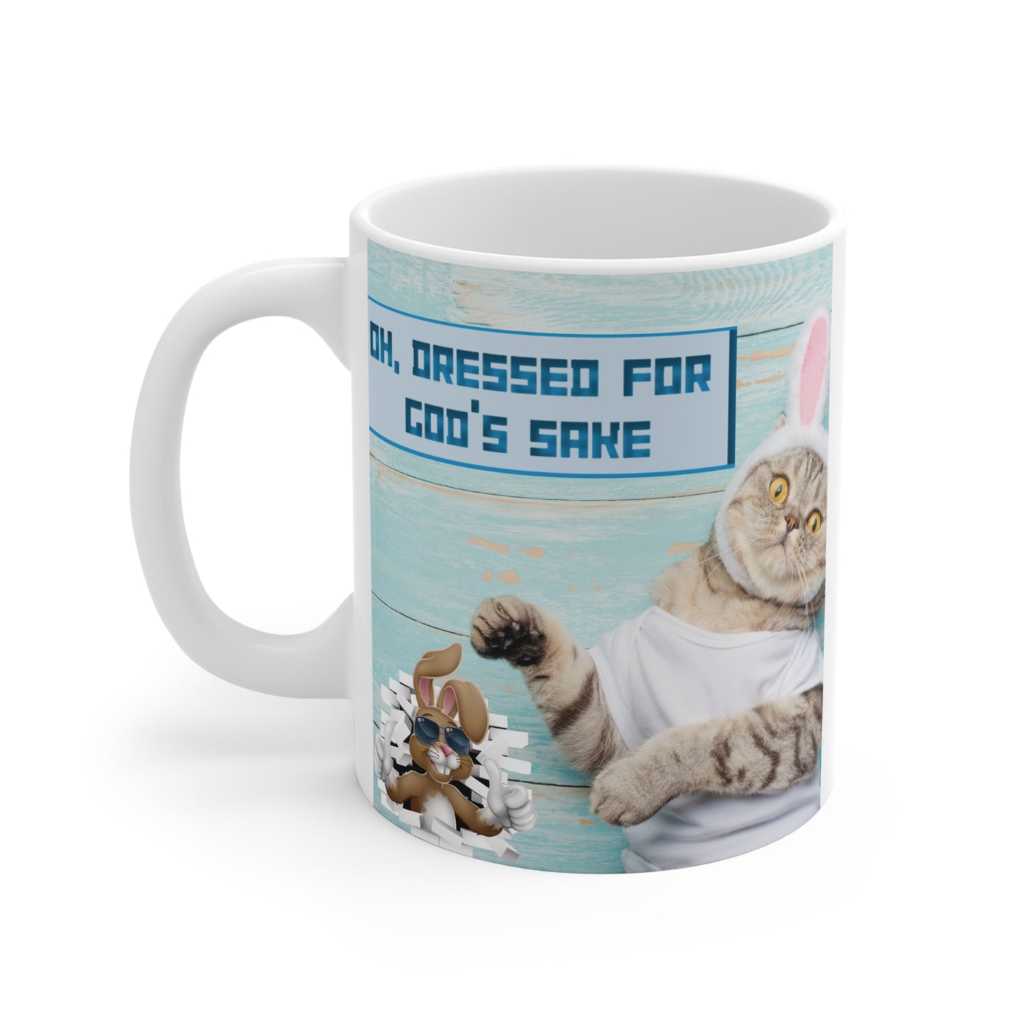 Funny Easter cat mug with bunny ears costume and ‘Oh, dressed for cod’s sake’ pun quote on pastel wood background