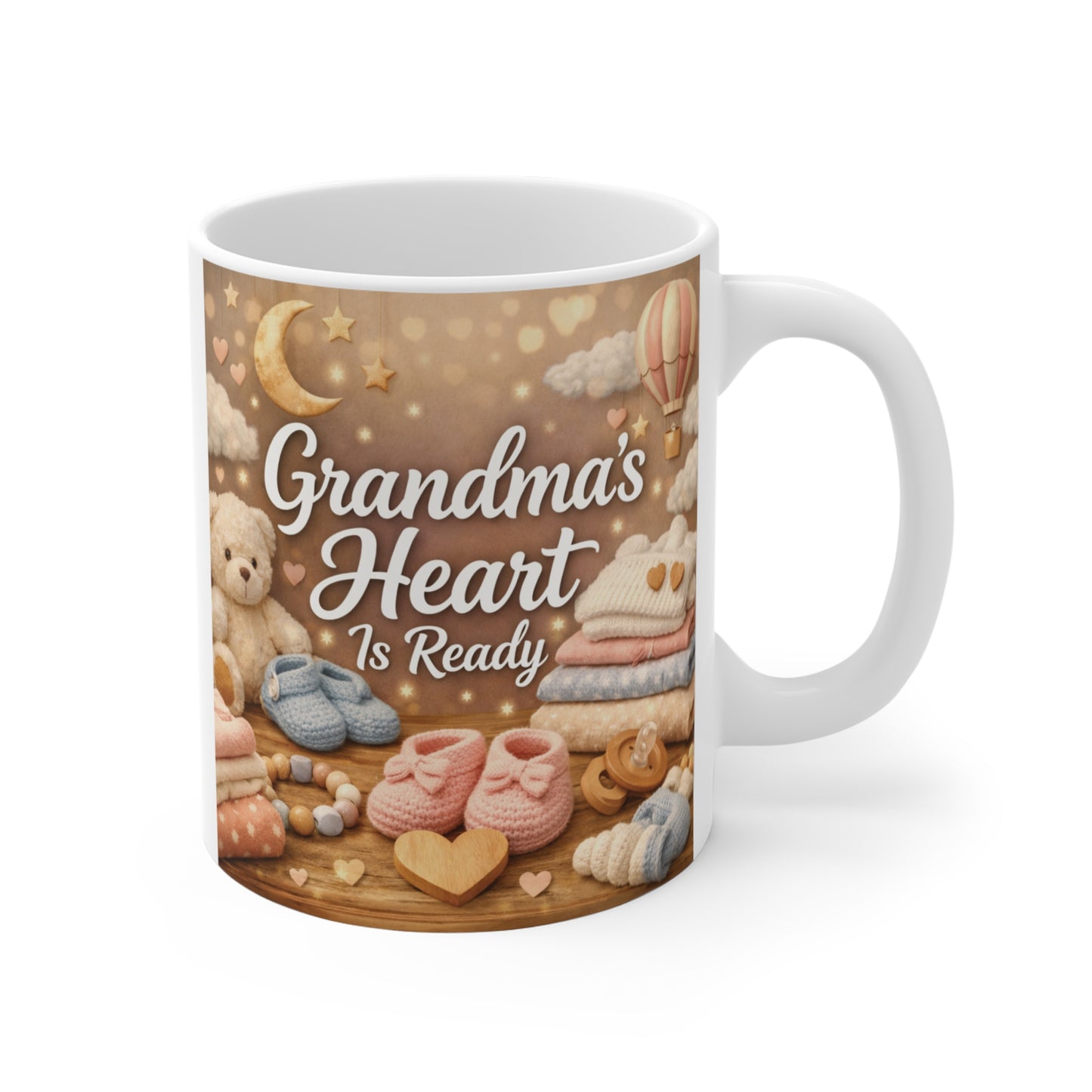 Grandma's Heart Is Ready 11oz ceramic coffee mug featuring watercolor baby booties and teddy bear for pregnancy announcement gift.