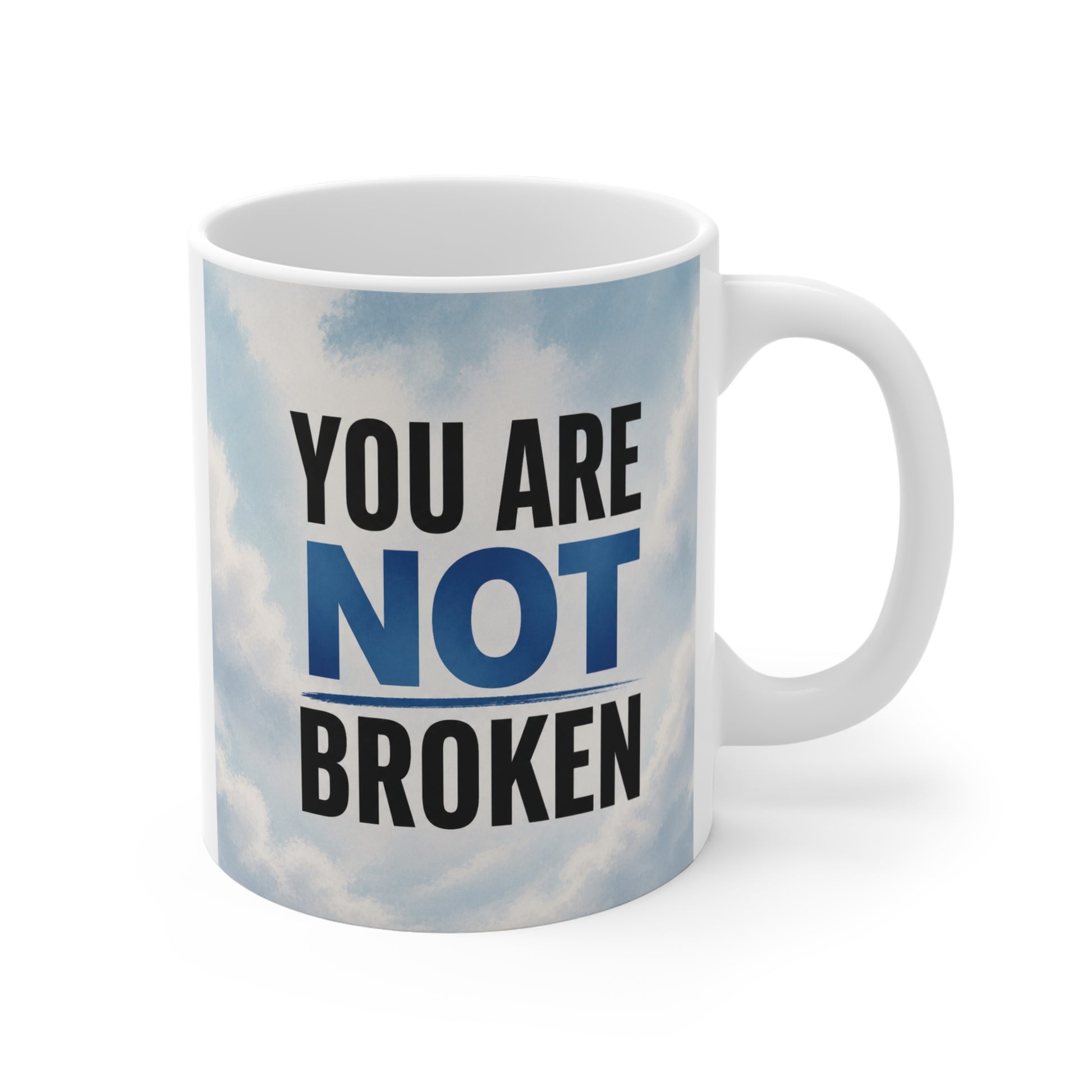 11oz ceramic mug with “You Are Not Broken” inspirational quote on a soft blue sky background, motivational coffee cup for mental health and self-love