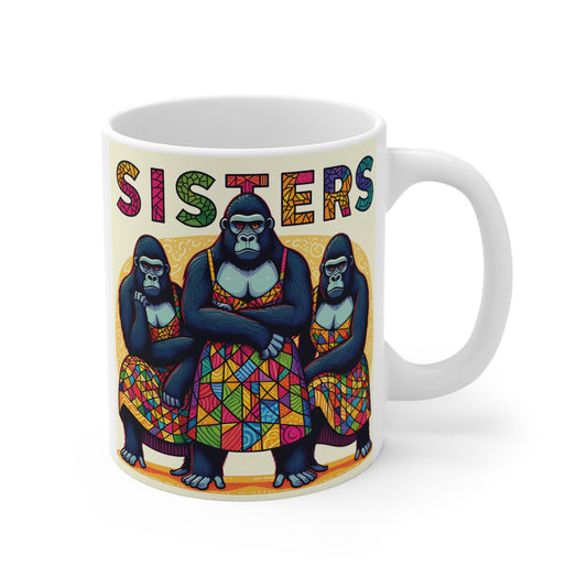 White ceramic mug featuring three colorful gorillas wearing patterned dresses with the word Sisters above them, funny sisterhood gift design.