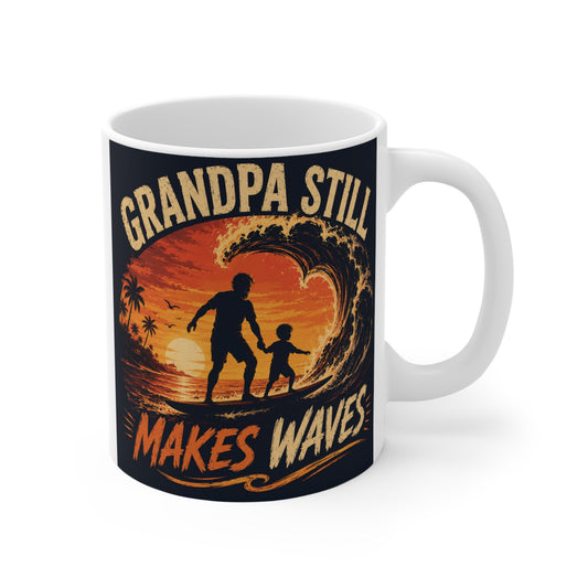 11oz ceramic coffee mug featuring a silhouette of a grandpa and grandchild surfing together at sunset with the phrase Grandpa Still Makes Waves.